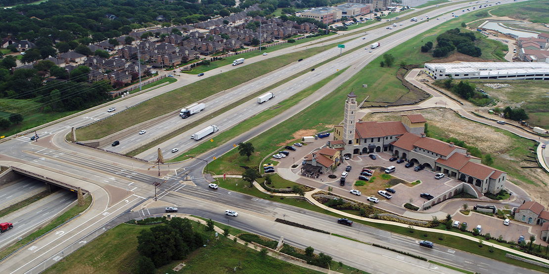 An aerial view of highway running next to Westlake Entrada