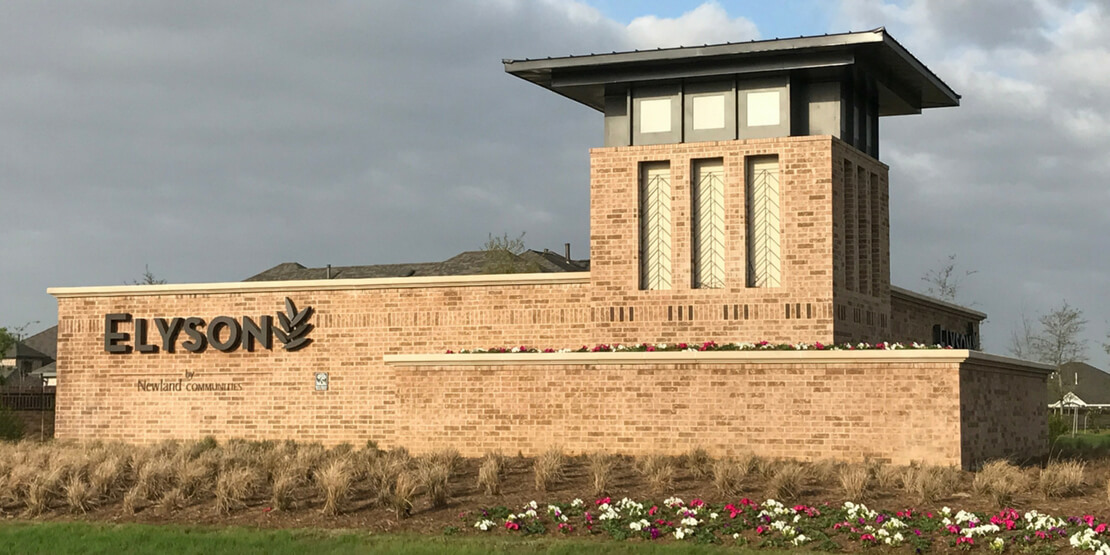 The brick front entrance sign of the Elyson community developed by BGE, Inc.