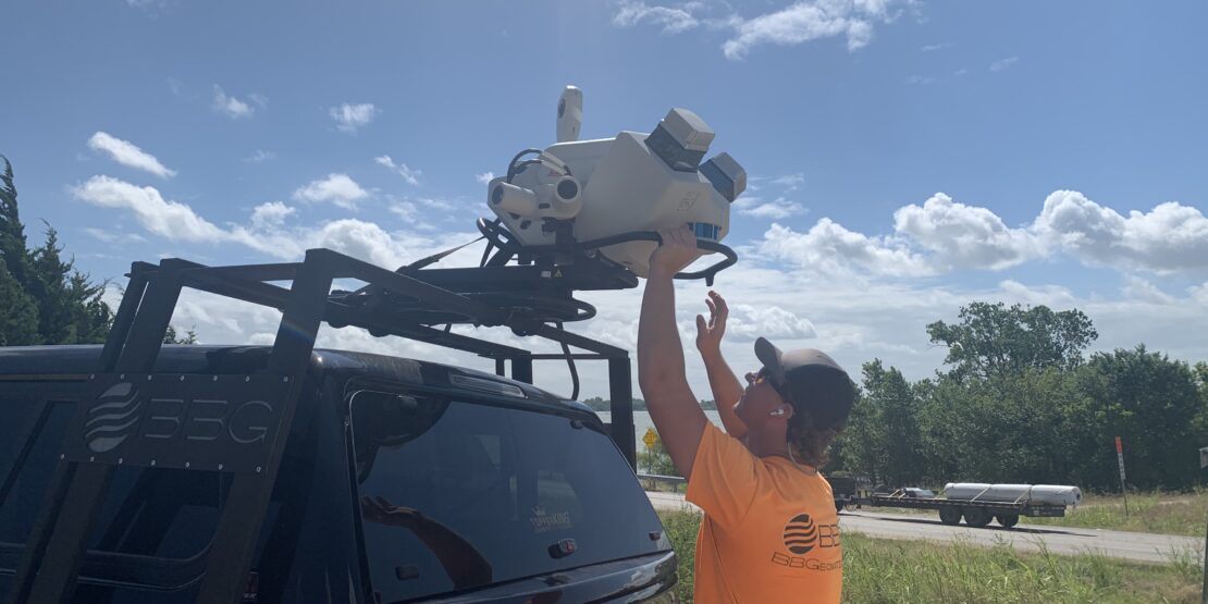 AN S&B technician preparing lidar to survey Lake Lavon/FM 3286