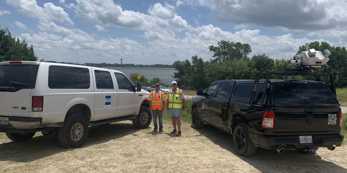 Two BGE construction workers standing next to BGE marked vehicles at Lavon/FM 3286