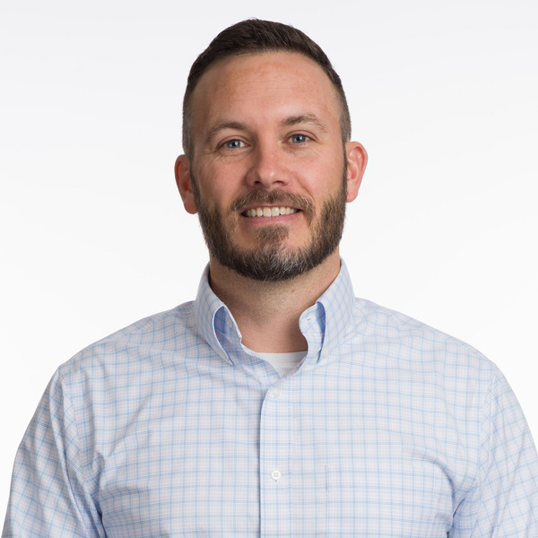 Professional headshot of Nick Vann, smiling against a white background.