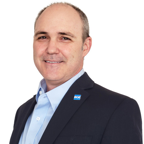 Professional headshot of James Kelley, smiling against a white background.