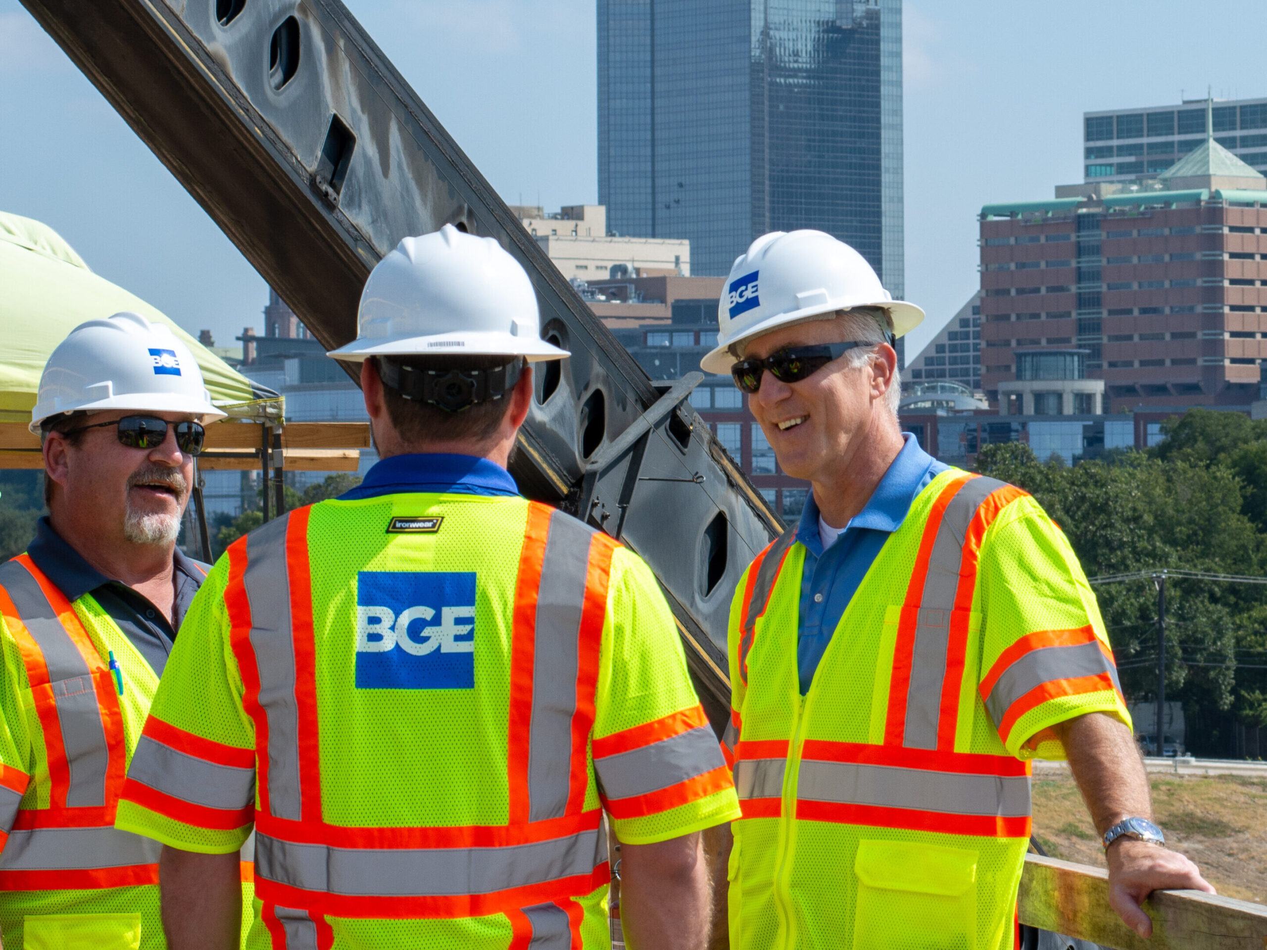 Field workers on Trinity River Vision project with skyline in Fort Worth, TX.
